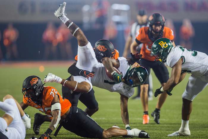 Oct 2, 2021; Stillwater, Oklahoma, USA; Oklahoma State Cowboys linebacker Kamryn Farrar (44) tackles Baylor Bears running back Trestan Ebner (1) during the fourth quarter at Boone Pickens Stadium. Mandatory Credit: Brett Rojo-USA TODAY Sports